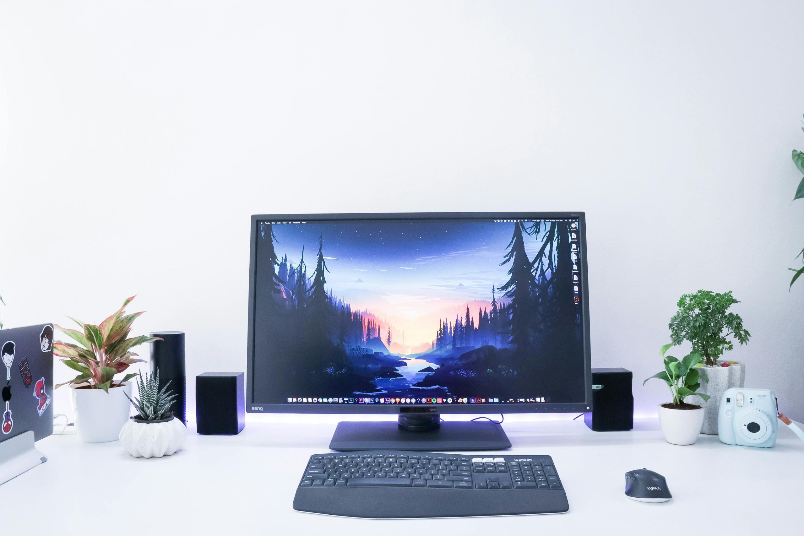 pexels photo 2585916 2585916 Contemporary desk setup featuring a monitor, plants, and electronic devices in a sleek, minimalist design.