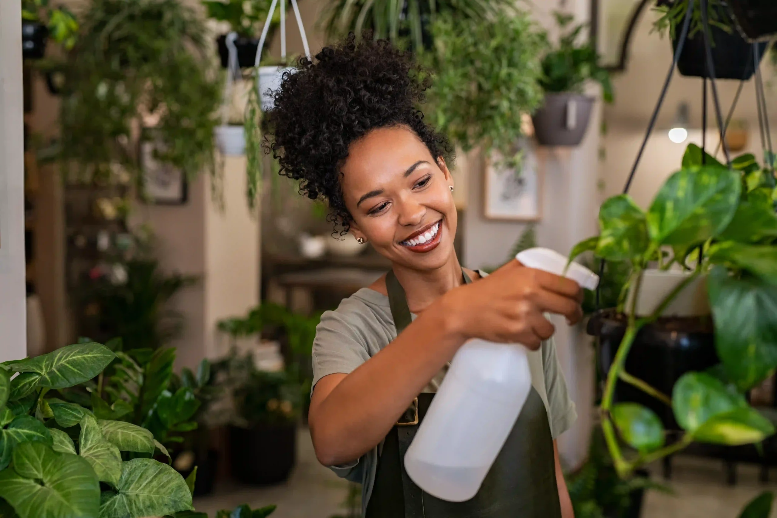 african american woman watering plants in botany s 2026 01 06 10 44 26 utc