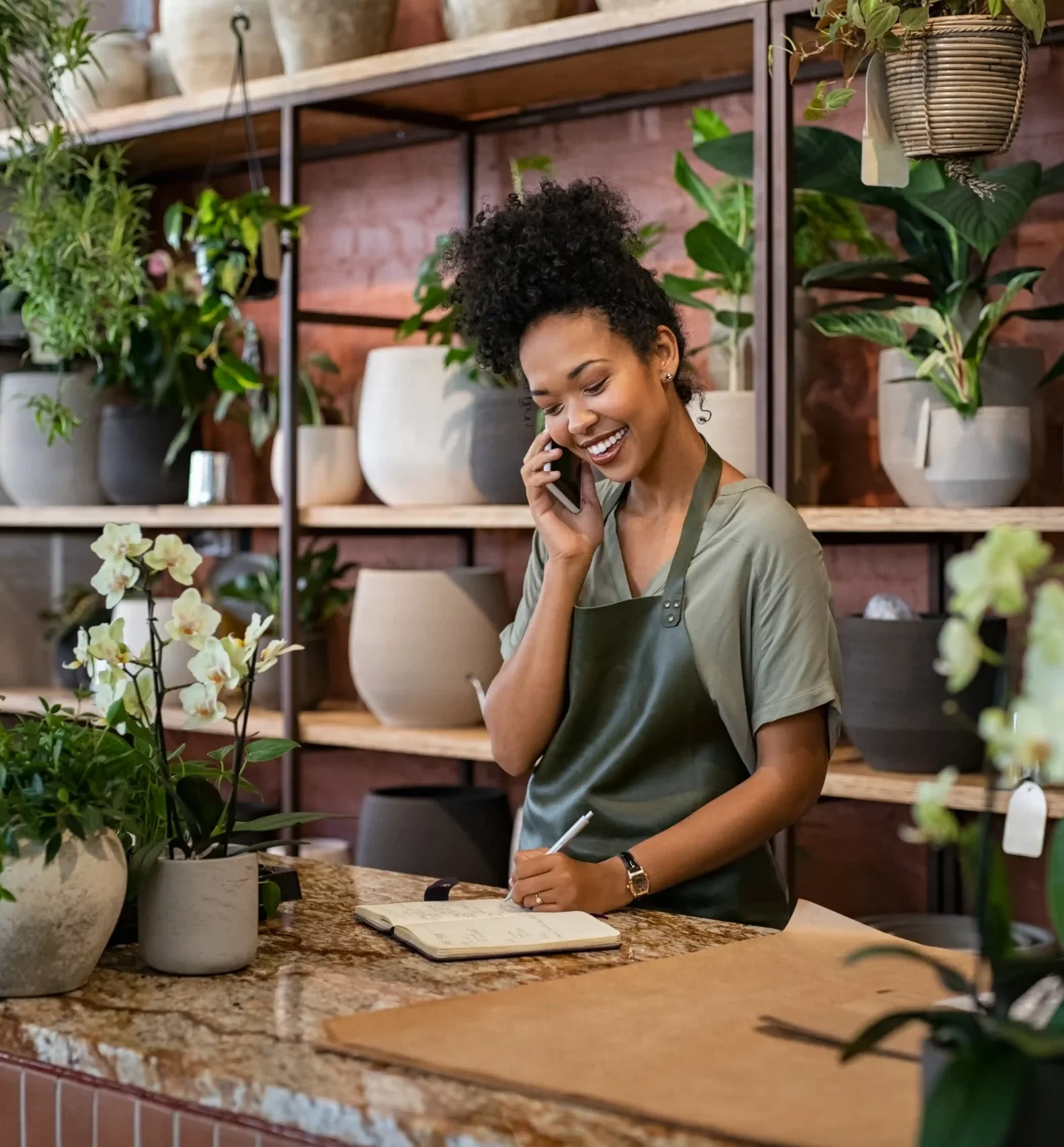 florist takes an order on the phone at flower shop 2026 03 17 20 09 05 utc
